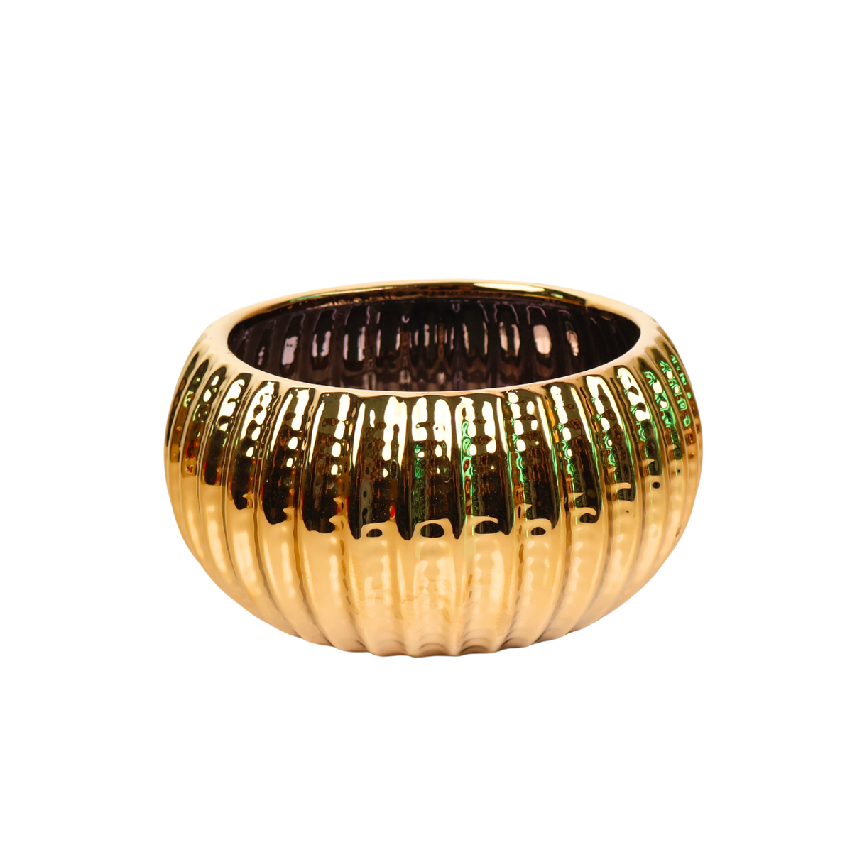 Brass bangle and gold candle holder on metal surface.