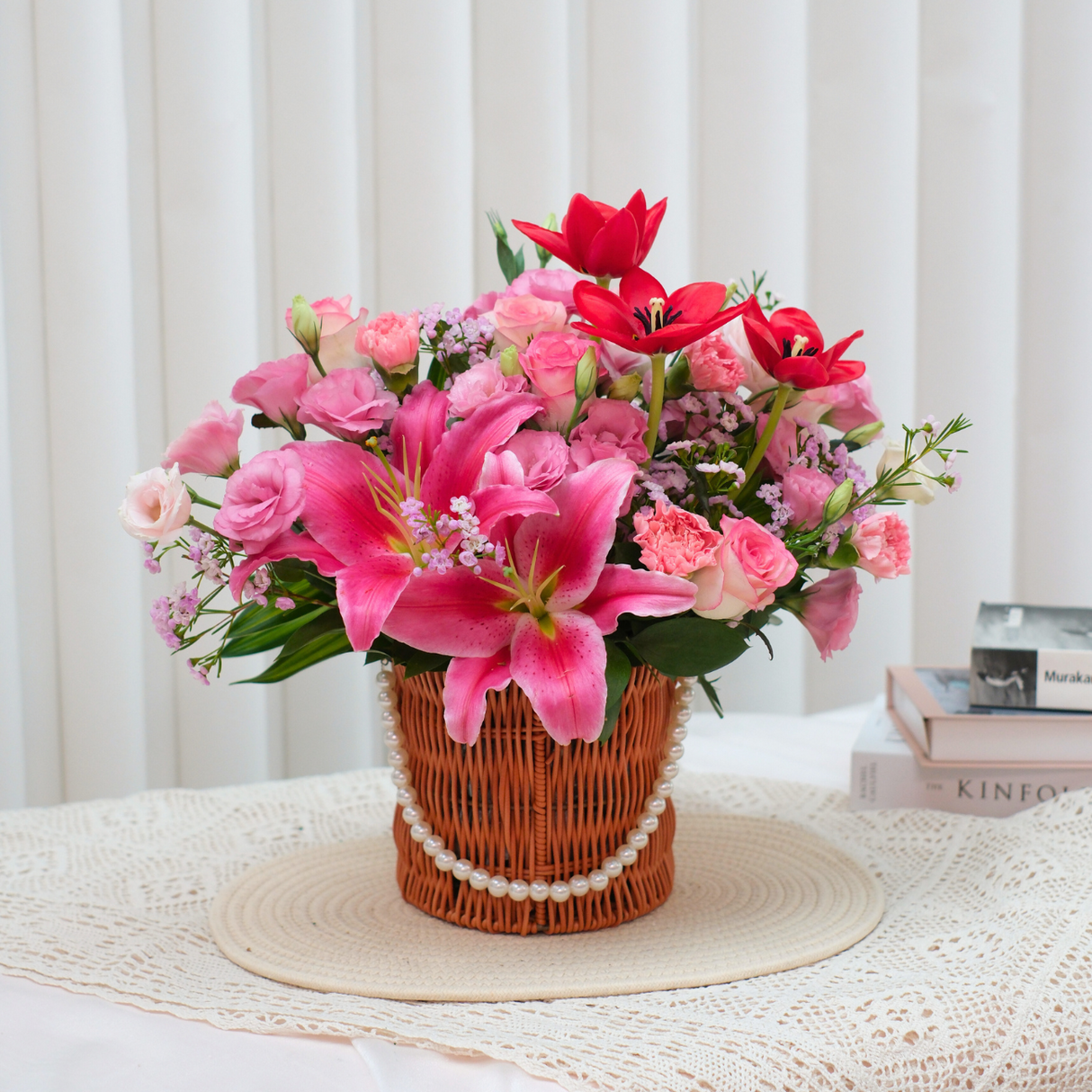 Pink flower bouquet in flowerpot on furniture.