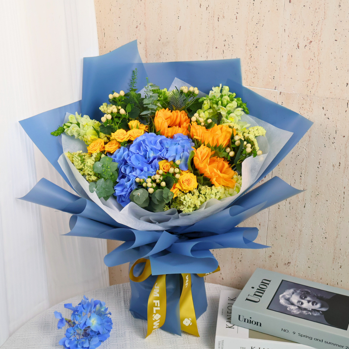 Yellow flower bouquet with boxed packaged goods.