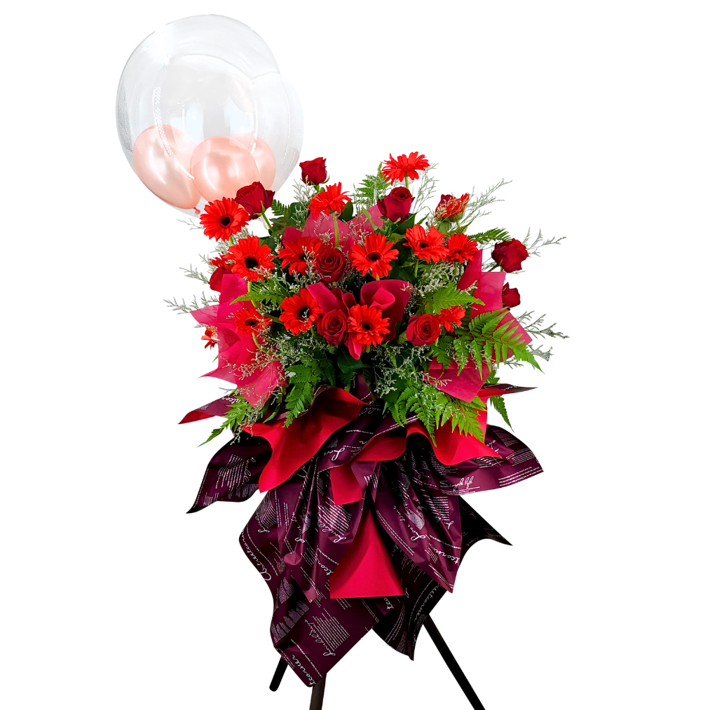 Red artificial flower bouquet with pink petals.