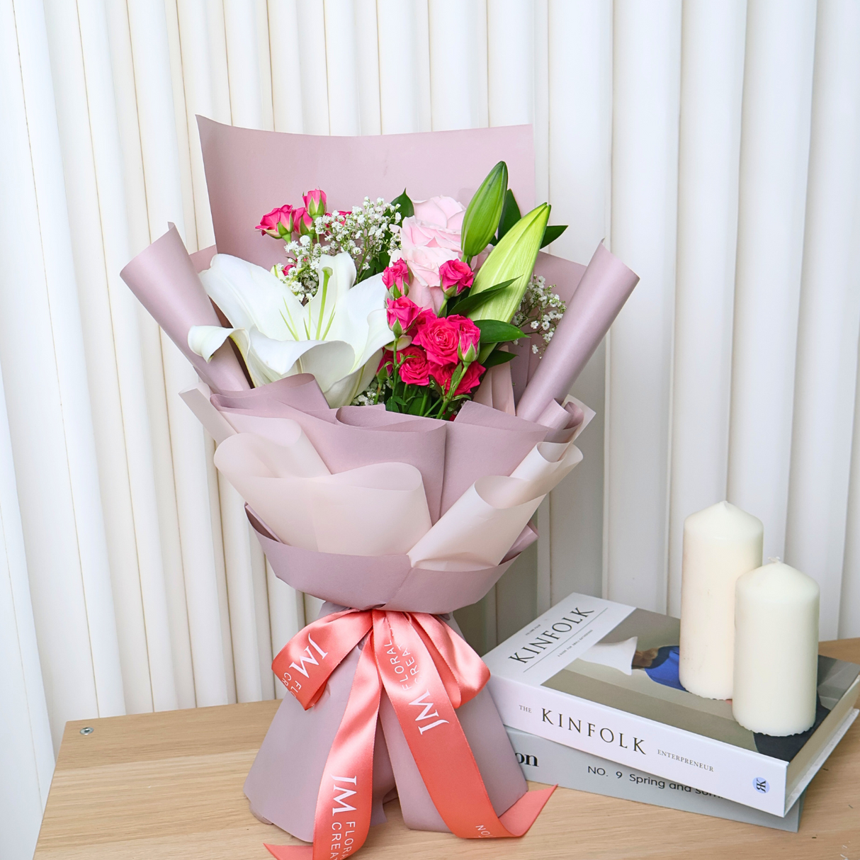 Pink artificial flower bouquet in vase.