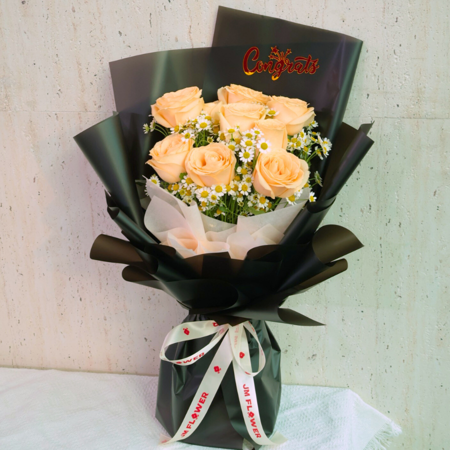 Colorful flower bouquet with garden roses and artificial flowers.