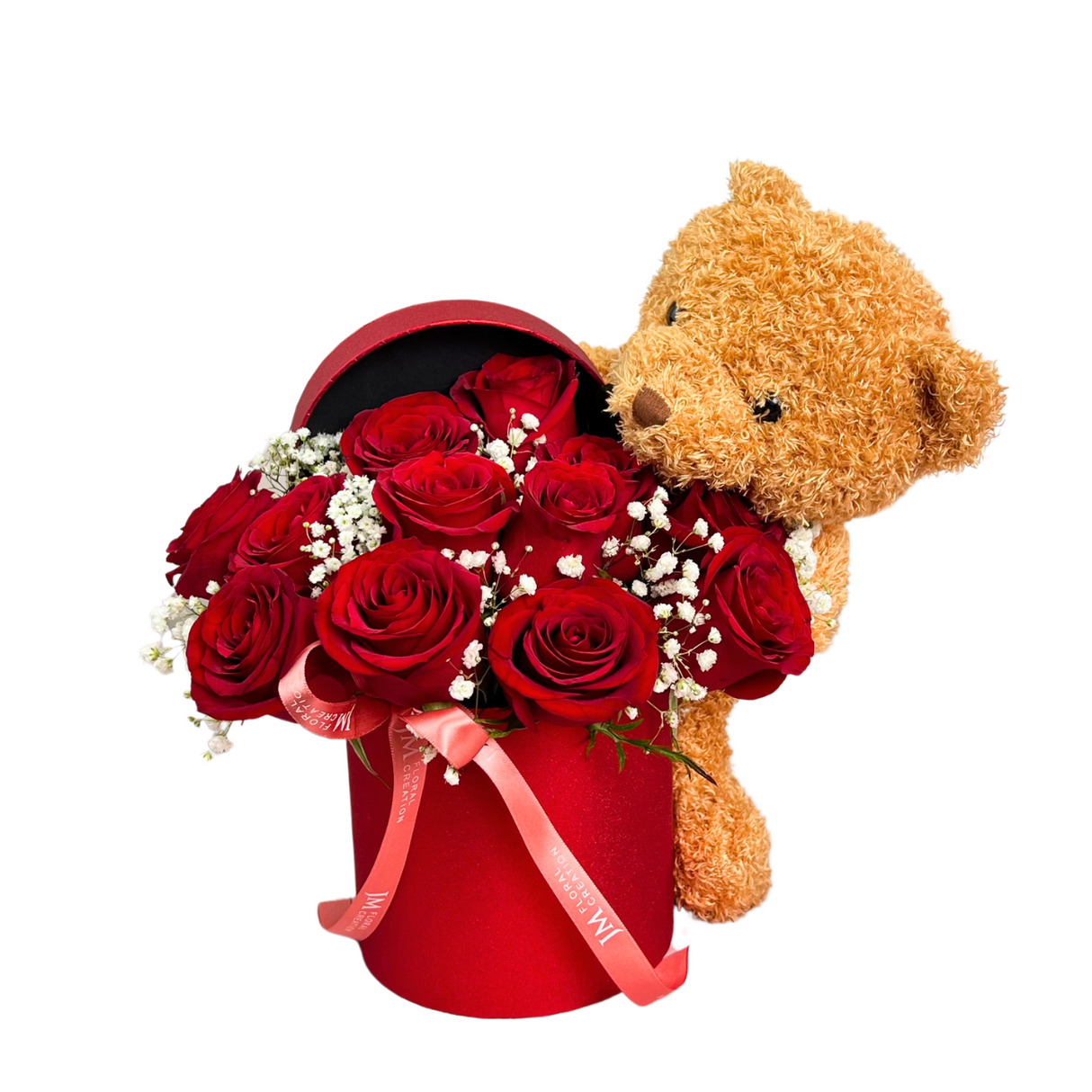 Teddy bear holding red flower bouquet.