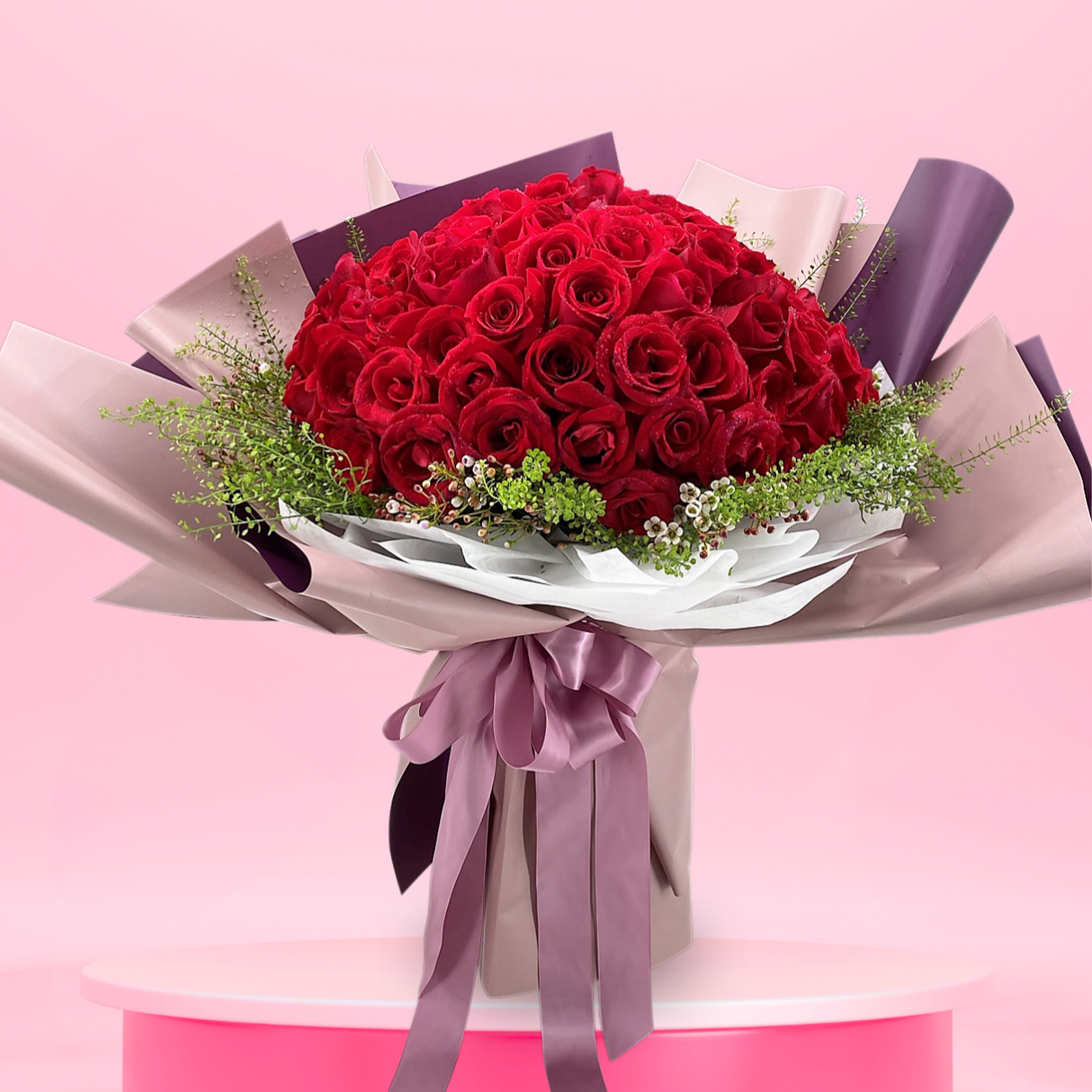 Pink garden rose bouquet with artificial flowers.