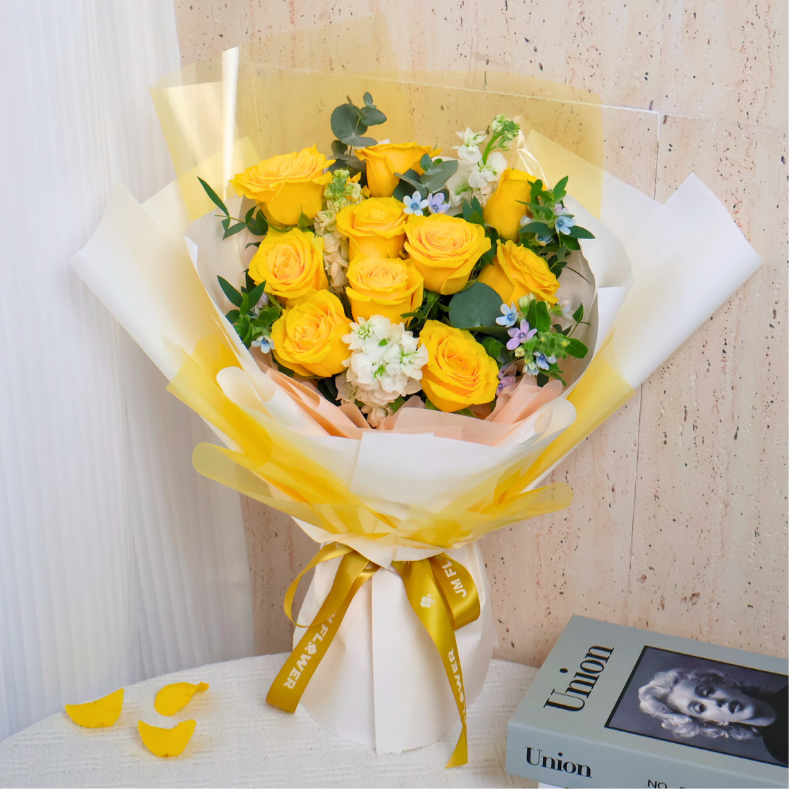 Yellow flower bouquet with garden roses and petals.