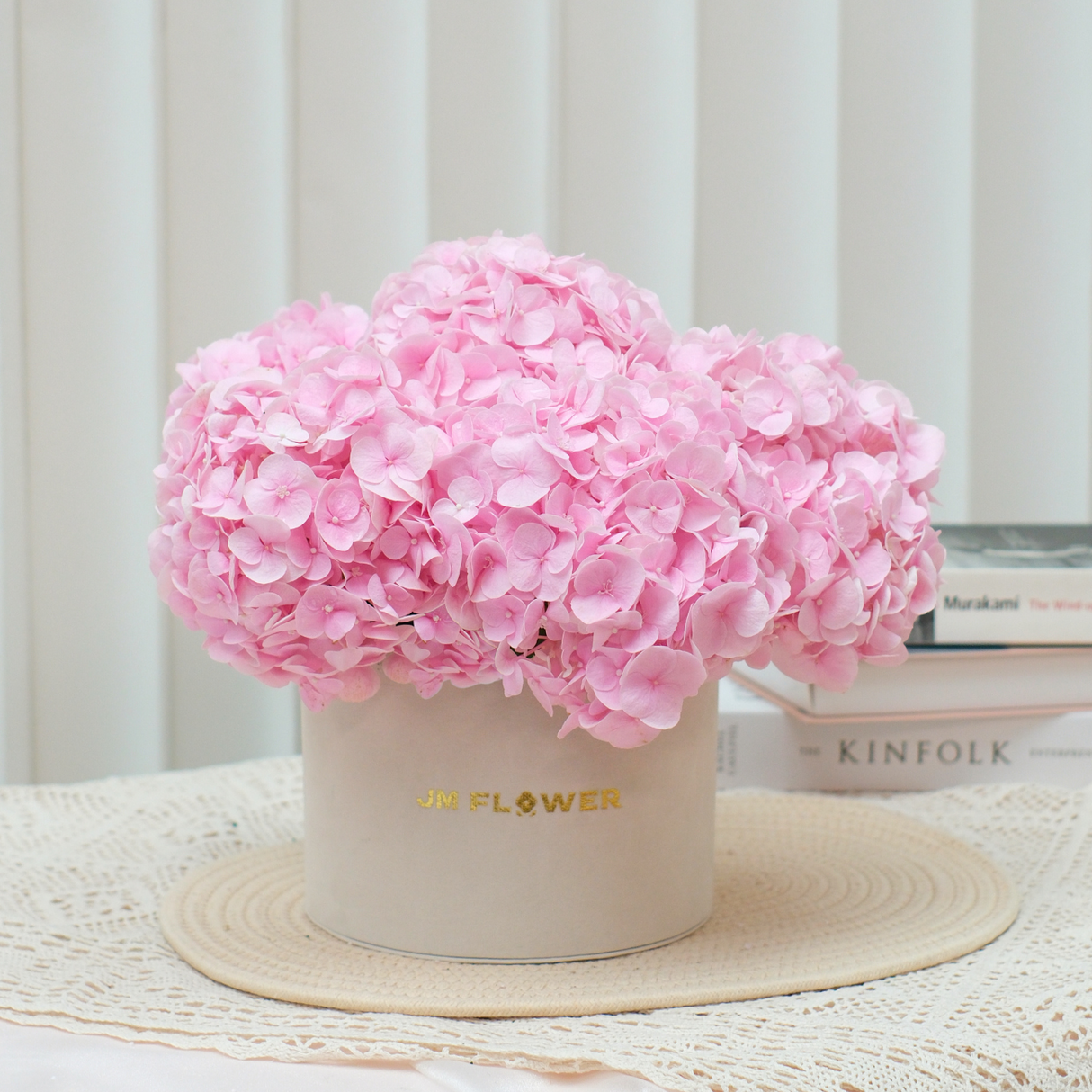 Pink artificial flower bouquet in vase.