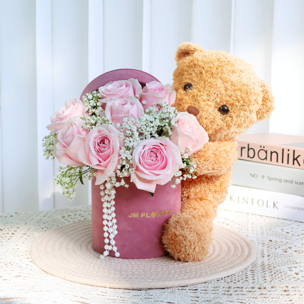 Pink flower bouquet with teddy bear.