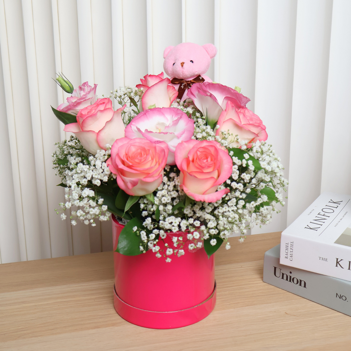 Pink flower bouquet in vase with Kinfolk logo.