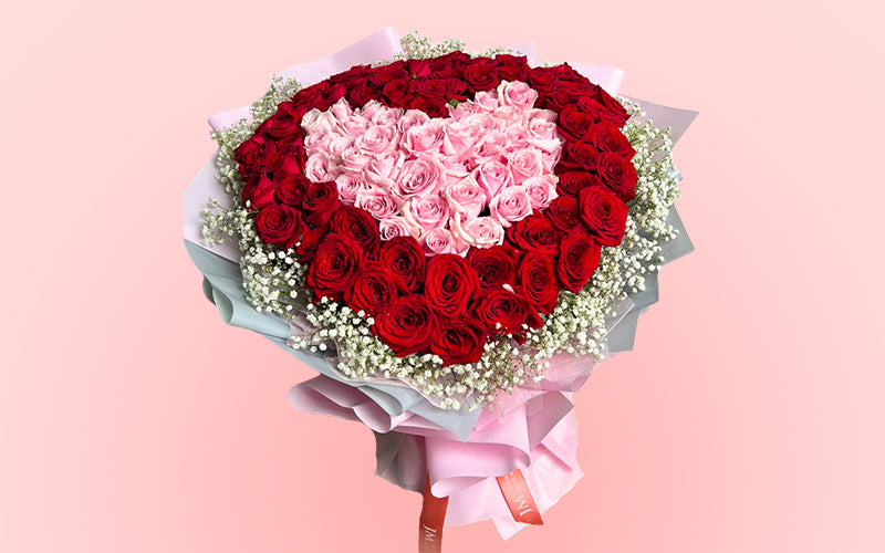 A heart-shaped bouquet of red and pink roses from JM Flower