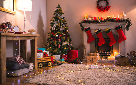 Festive Christmas living room with tree, stockings, and plant garland decor