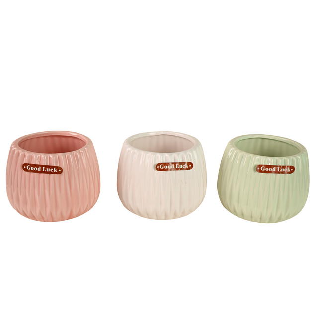 Assorted fruit in vase with flowers.