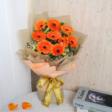 Orange flower bouquet in packaging.