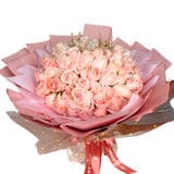 Pink garden rose bouquet with floristry arrangement.