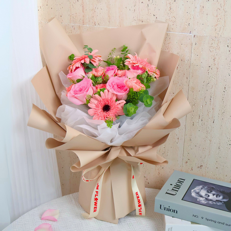 Pink artificial flower bouquet with petals.