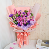 Pink garden rose bouquet with artificial flowers.